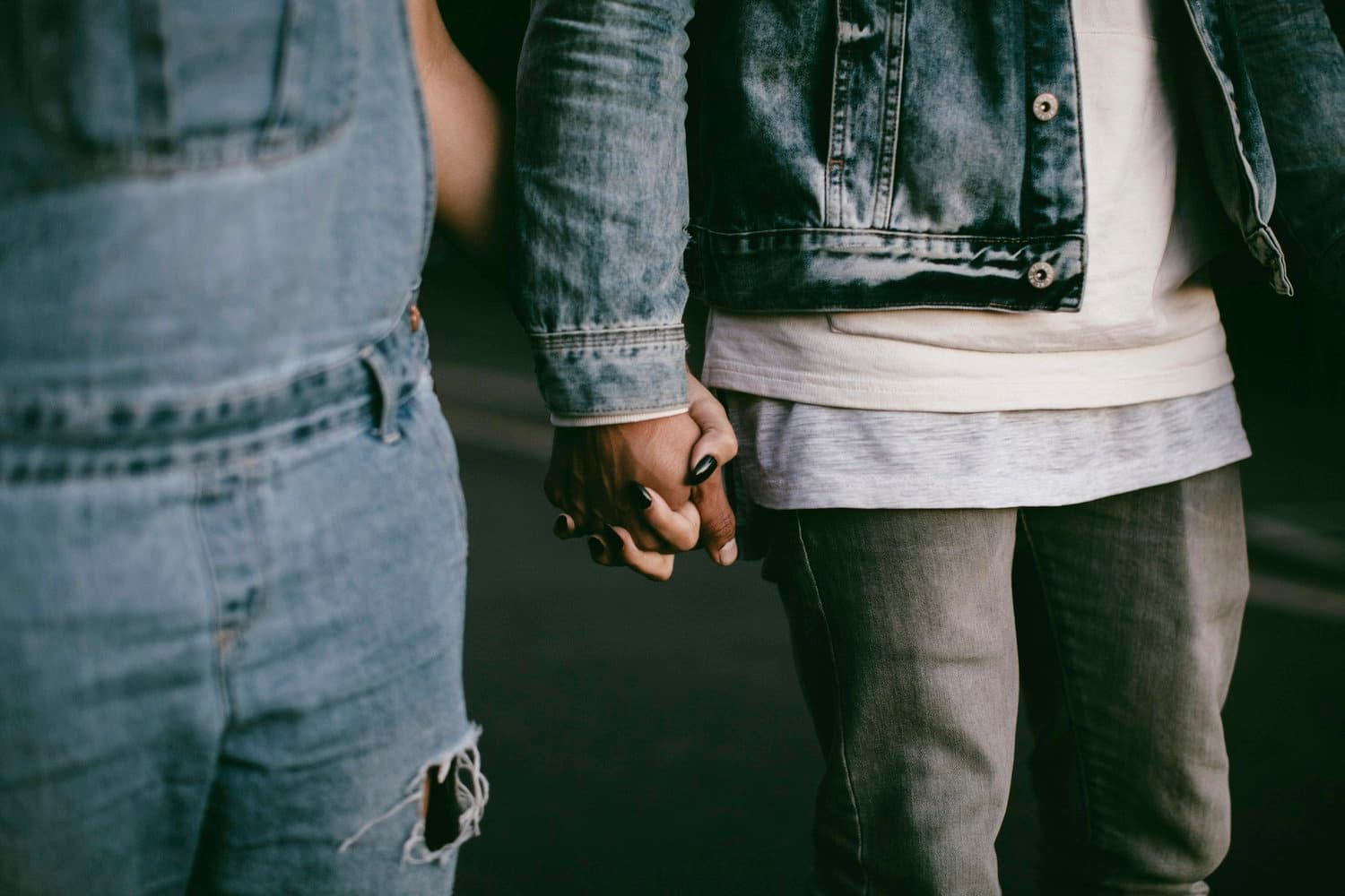 Two people holding hands